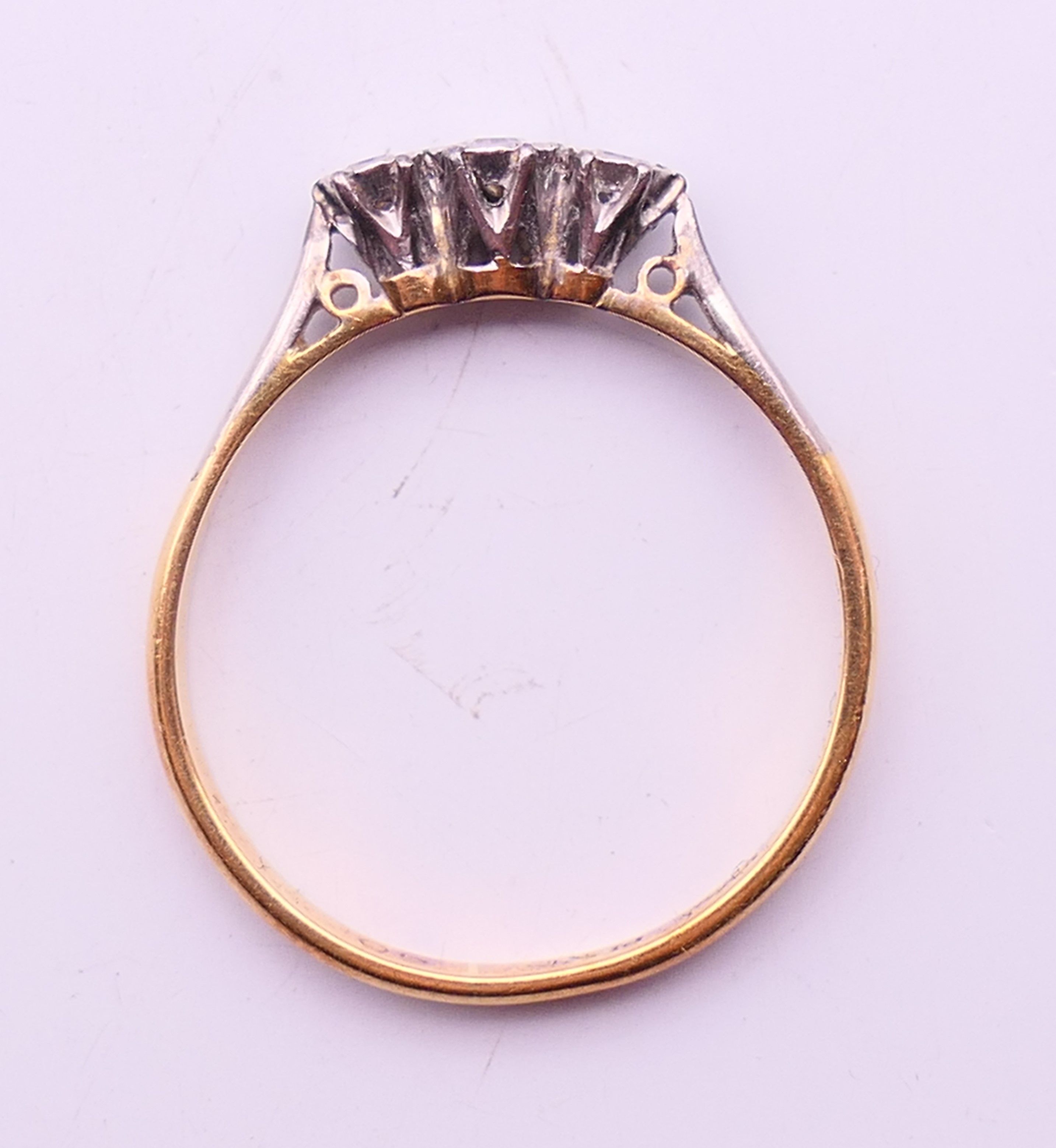 An 18 ct gold and platinum three-stone diamond ring. Ring size M. - Image 5 of 6