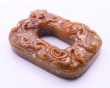An Archaic-style stone roundel. 6.5 cm long.
