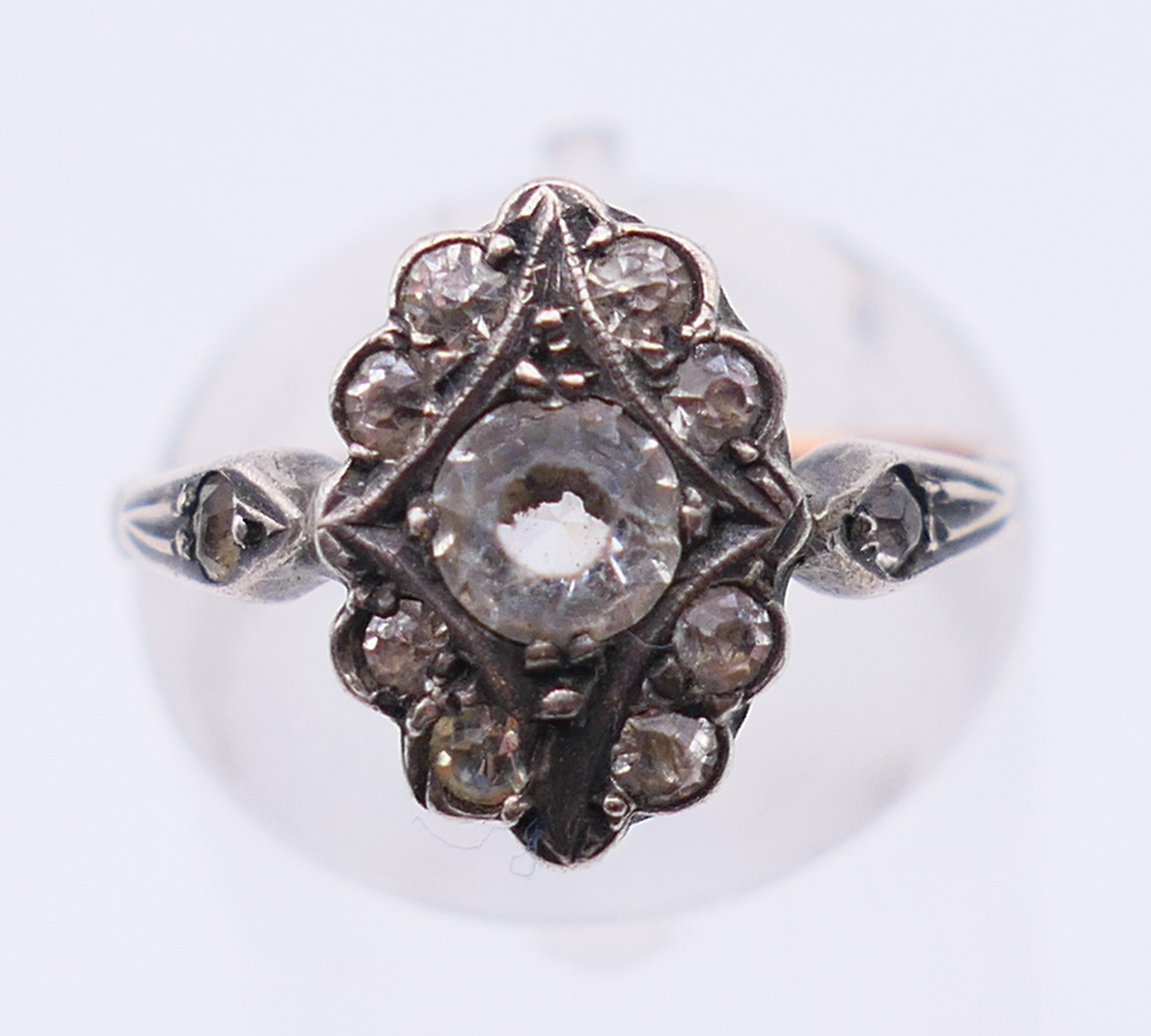 An antique silver and 9 ct gold paste ring. Ring size L/M.
