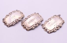 A set of three silver decanter labels for Sherry, Gin and Whiskey. Each 6 x 4 cm.