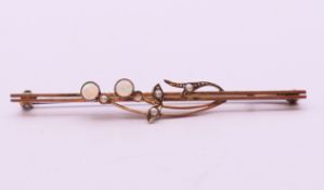 A 9 ct gold, opal and seed pearl bar brooch. 6 cm wide.