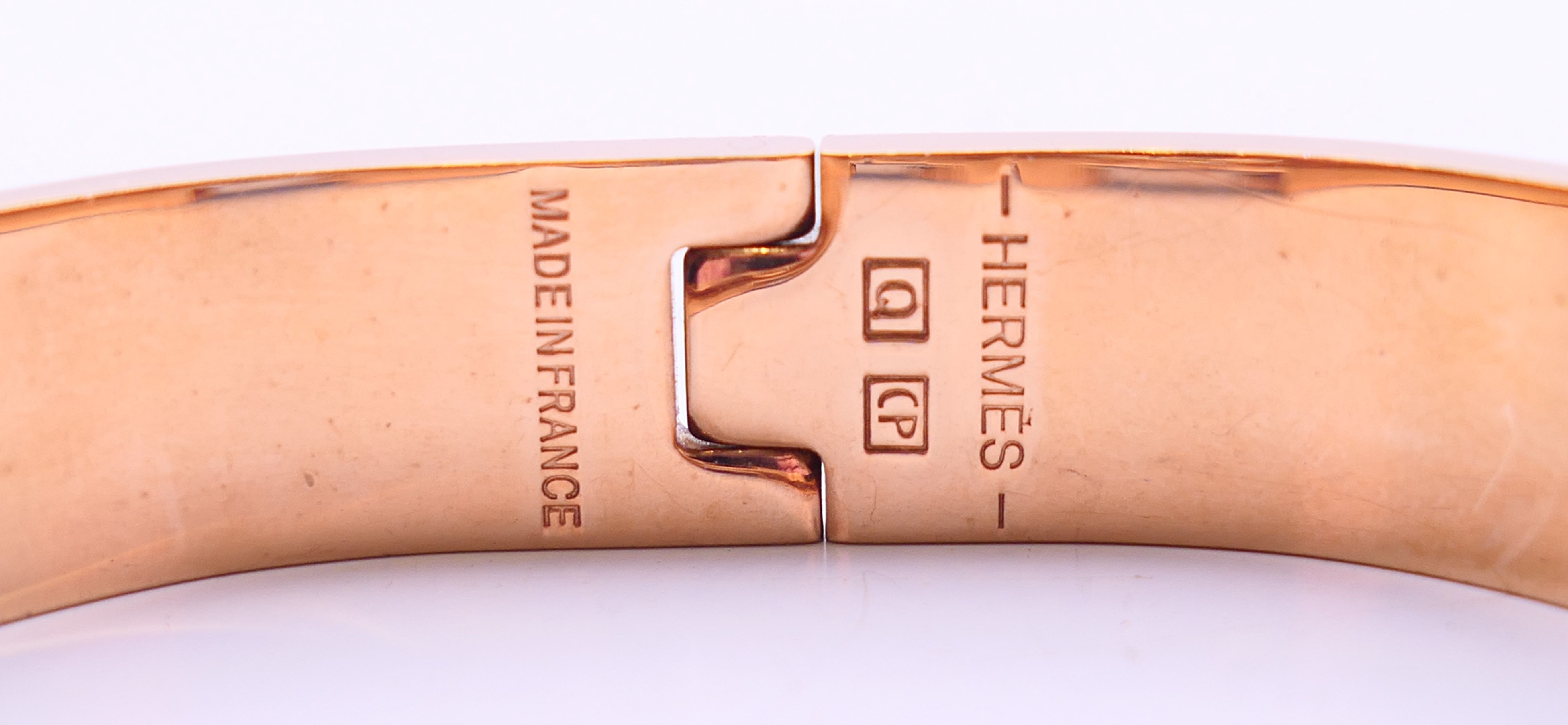 A Hermes Paris white enamel gold plated Clic H bracelet, in a Hermes box. 6. - Image 3 of 5