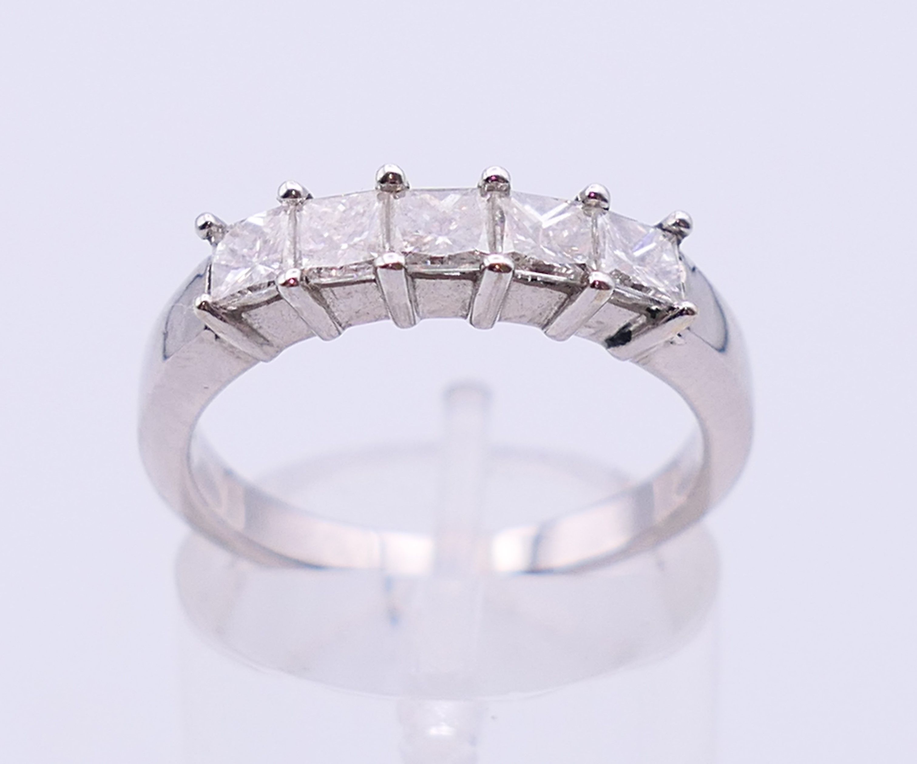 A 14 K white gold five-stone ring. Ring size O.