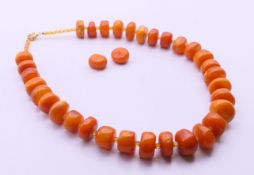 An amber bead necklace. 42 cm long. 68.9 grammes.