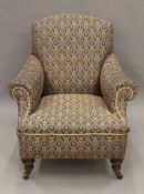A Victorian upholstered armchair. 85 cm wide, 91 cm high, 81 cm deep overall, seat 59 cm deep.