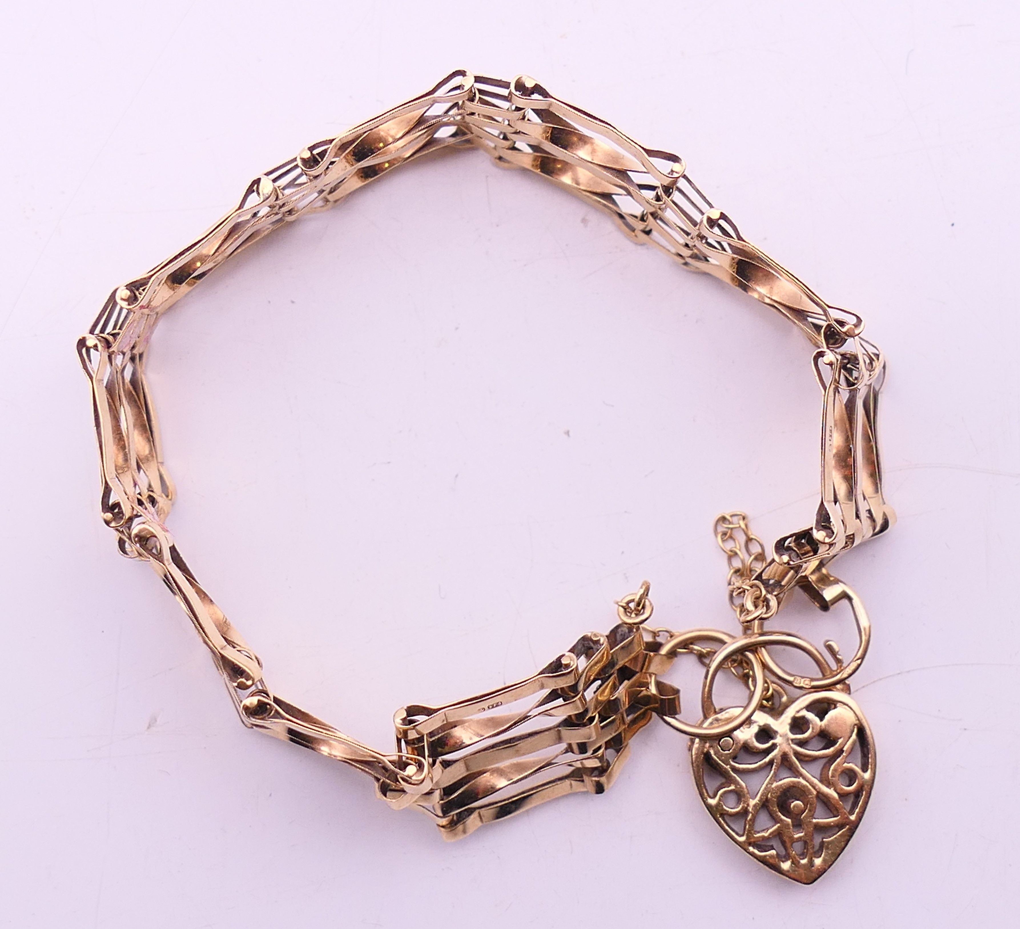 A 9 ct gold gate link bracelet with heart padlock. 18 cm long. 12. - Image 5 of 9