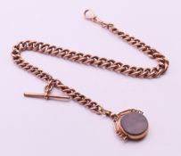 A 9 ct gold watch chain and a 9 ct gold fob. Chain 32 cm long, fob 2 cm diameter. The chain 24.