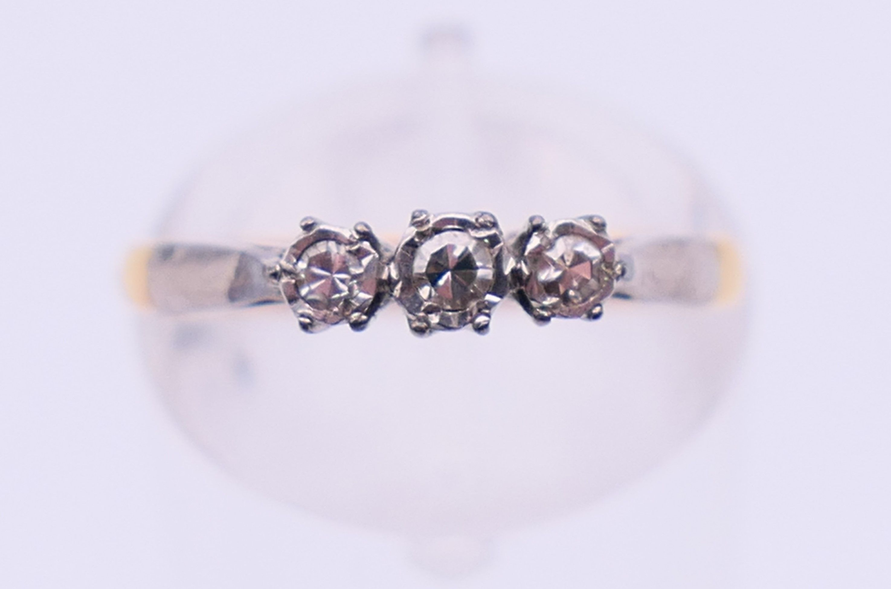 An 18 ct gold and platinum three-stone diamond ring. Ring size M. - Image 2 of 6