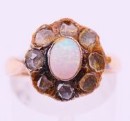 A Victorian unmarked gold, diamond and opal cluster ring. Ring size M.