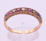 A 9 ct gold diamond and ruby ring. 2.7 grammes total weight. Ring size S.