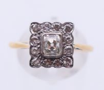 An unmarked gold and square set diamond ring. Ring size R.