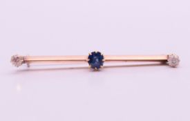 A gold, diamond and sapphire bar brooch. 4.5 cm wide.
