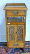 A Victorian carved oak smoker's cabinet with accessories including a pottery tobacco pot and