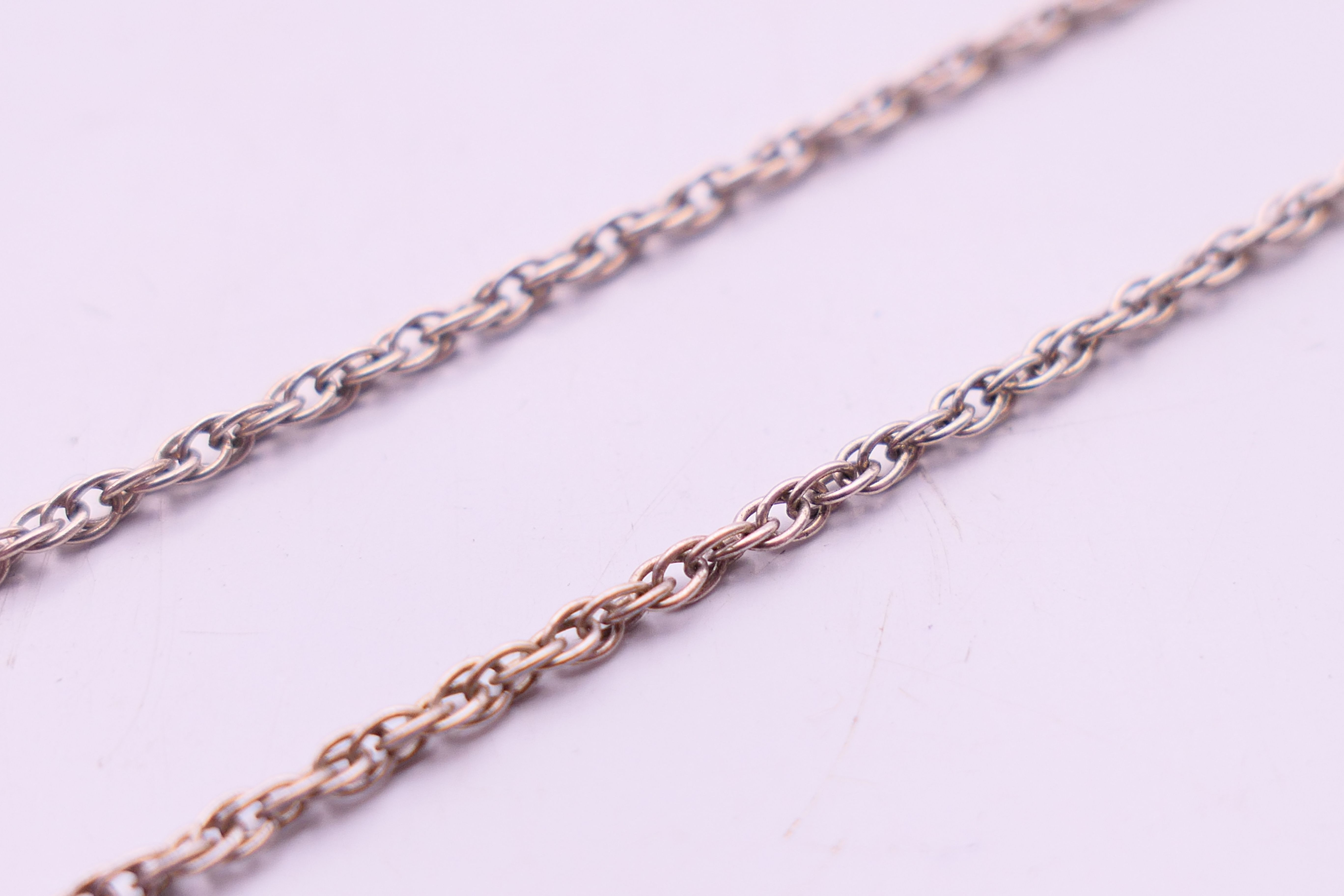A silver peridot and blue topaz pendant and chain. Pendant 2 cm high, chain 40 cm long. - Image 5 of 5