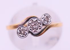 An 18 ct gold diamond twist crossover ring. Ring size I/J.