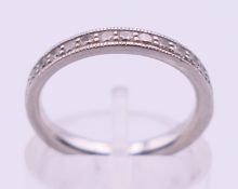 A platinum half eternity ring. Ring size J.