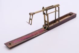 A 19th century mahogany folding Guinea scale. 13.5 cm wide.