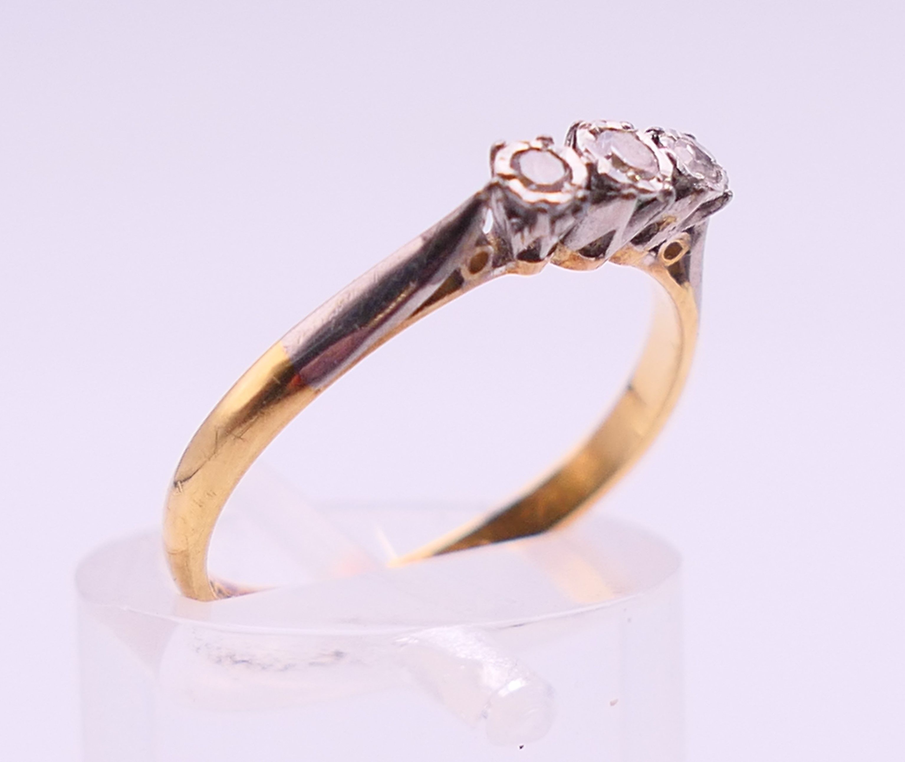 An 18 ct gold and platinum three-stone diamond ring. Ring size M. - Image 3 of 6