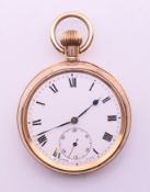 A gold plated pocket watch. 5 cm diameter.
