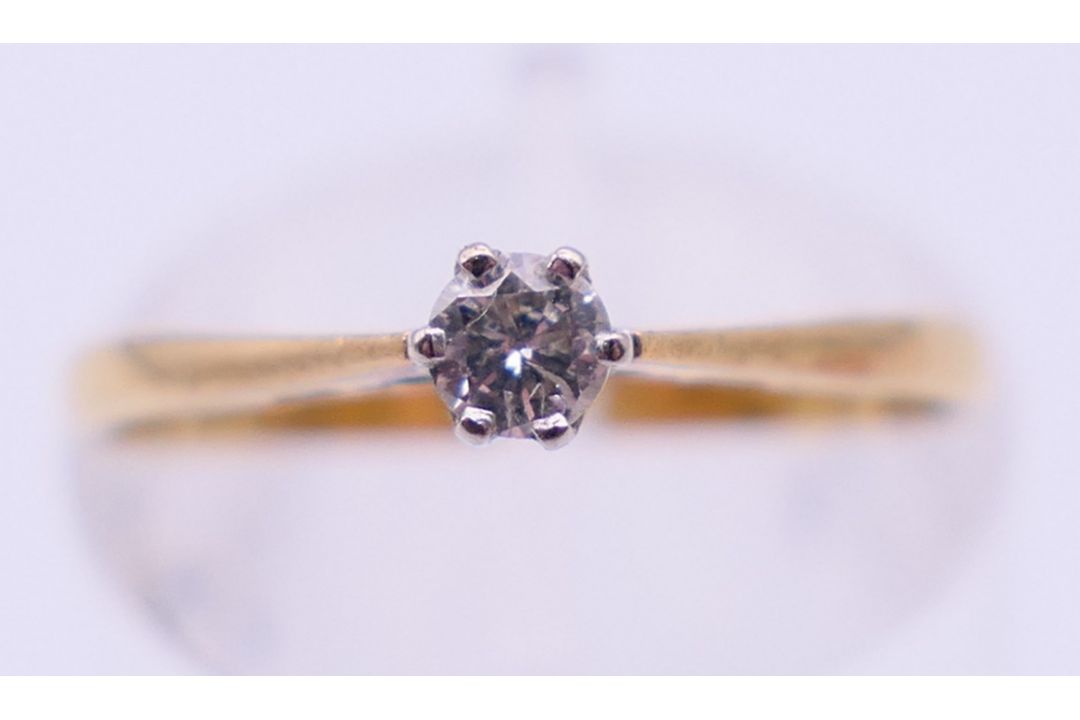 An 18 ct gold, diamond solitaire ring. 1.5 grammes total weight. Ring size K. - Image 1 of 6