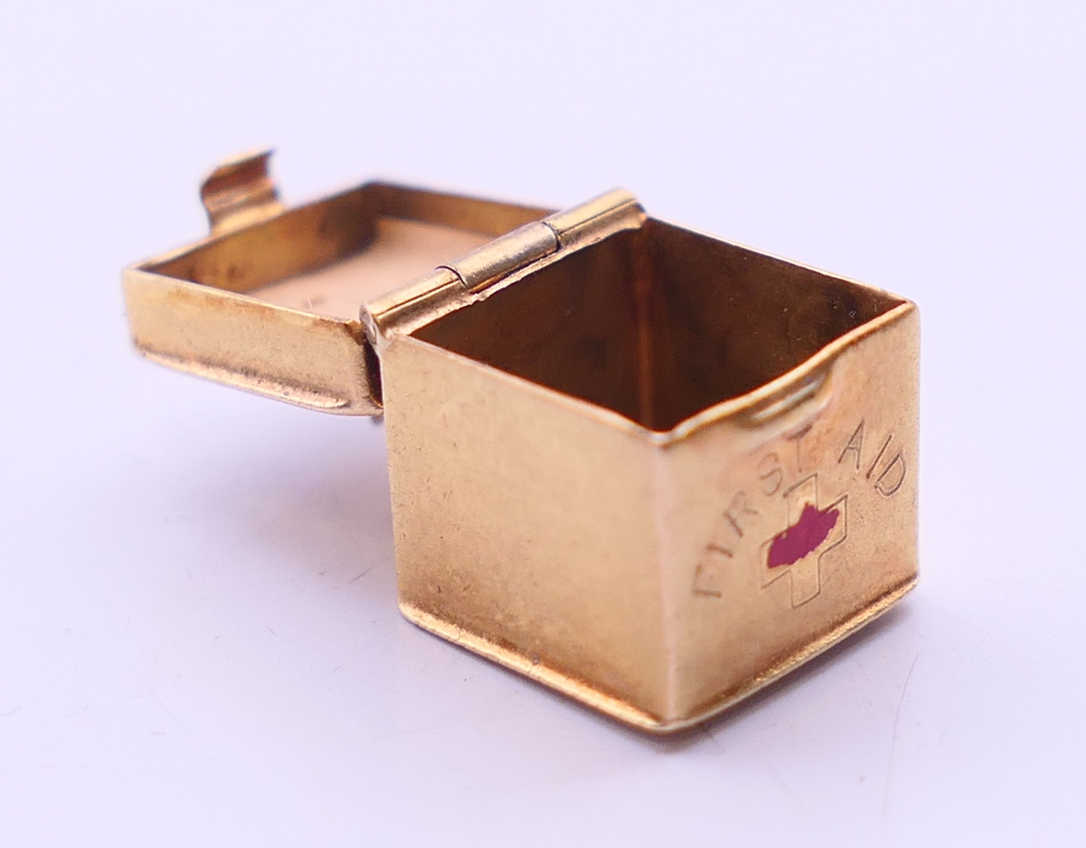 Three 9 ct gold charms to include: a 'first aid' box, - Image 13 of 14