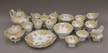 A 19th century Rockingham florally and gilt-painted porcelain tea set. The teapot 28 cm long.