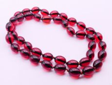 A string of beads. 84 cm long.