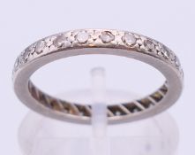 An 18 ct white gold full eternity ring. Ring size K/L.