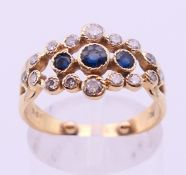 A 9 ct gold diamond and sapphire ring. Ring size L.
