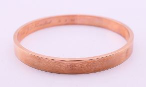 A 9 ct gold bangle, the inner band inscribed 'A token of appreciation from J G Hemsted 31.3.28'. 8.