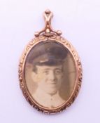An unmarked 9 ct gold photograph locket. 5 cm high.