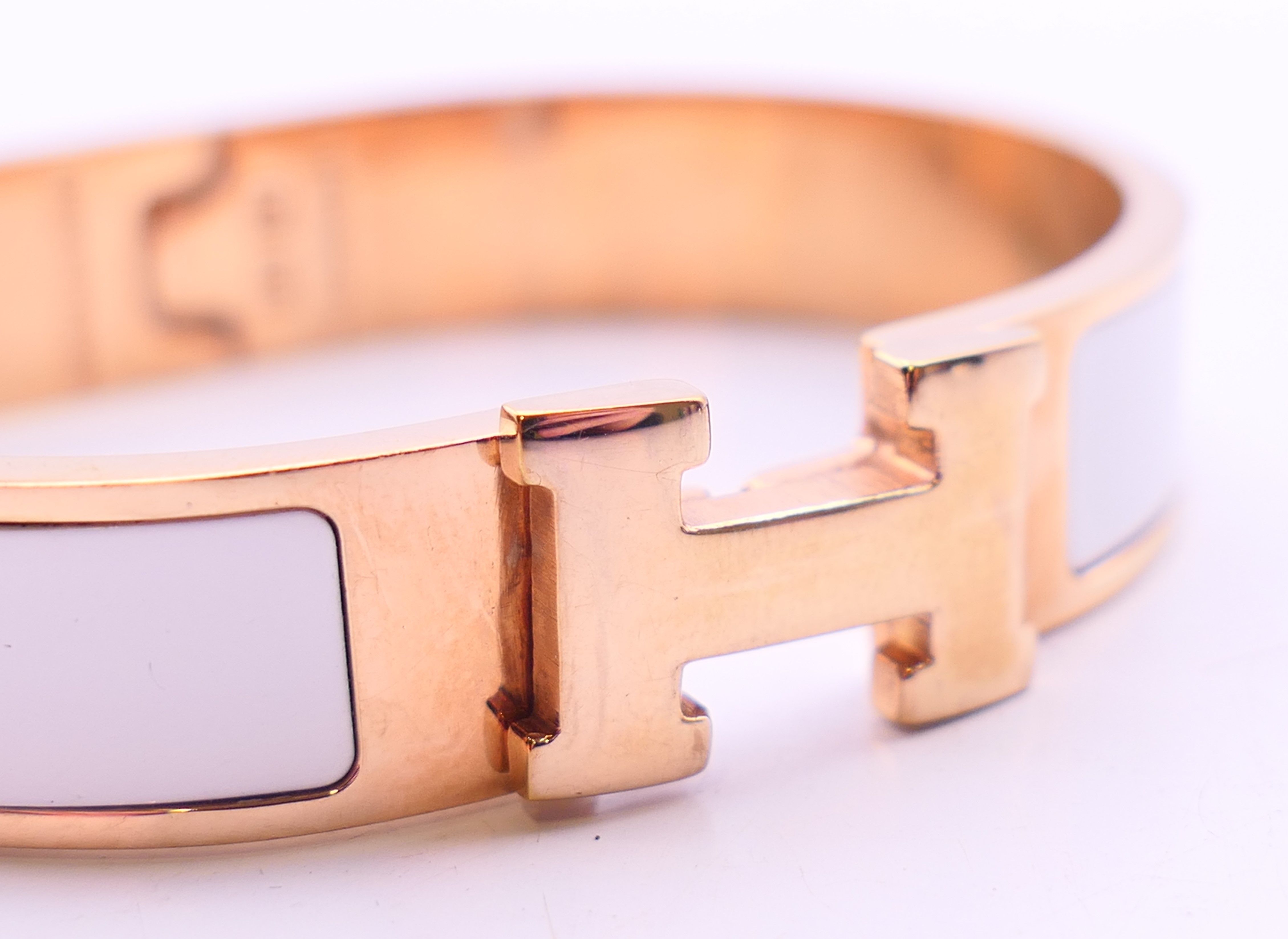 A Hermes Paris white enamel gold plated Clic H bracelet, in a Hermes box. 6. - Image 2 of 5