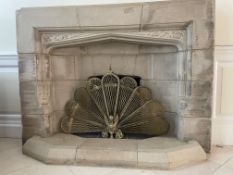 A composite stone (concrete and reconstituted stone) fireplace surround and hearth (18 pieces).