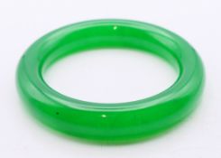 An apple green jade bangle. 6 cm inner diameter.