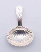 A silver George III caddy spoon with shell-shaped bowl, circa 1803. 8 cm high.