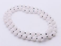 A string of white jade beads. 72 cm long.