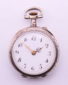 A silver and yellow metal fob watch. 3 cm diameter.