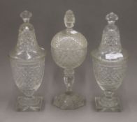 A pair of 19th century cut crystal glass lidded vases and another similar.