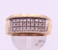 A 9 ct gold diamond cluster ring. 7.7 grammes total weight. Ring size T.