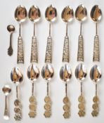Fourteen Chinese white metal spoons comprising two sets of six marked 'Silver 90' and two salt