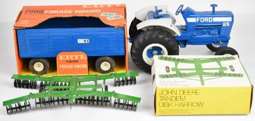 Three ERTL diecast model farming vehicles comprising Ford 8600 tractor, Ford Forage Wagon and John