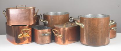 Nine large copper cooking pans including a pair of twin handled examples by Elkington, height of