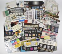 Fifty nine GB presentation packs plus a quantity of mint GB stamps, miniature sheets etc, face value
