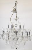 Murano style glass chandelier having two tiers of bulb holders with 12 on the lower and 6 on the
