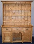 Pine dresser with dog kennel cubby hole between two cupboards, beneath three straight drawers,