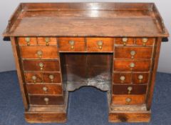 Antique oak ladies writing desk, fitted eighteen variously sized drawers with drop handles and oak
