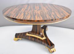 Victorian coromandel wood centre or breakfast table with gilt feet and border, diameter 130 x 74cm