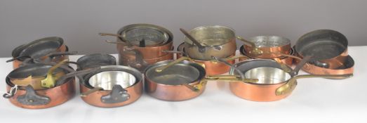 Approximately twenty five shallow copper saucepans or frying pans, many marked as being of French