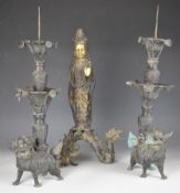 Three Chinese bronzes comprising a pair of Gu style sectional candlesticks with embossed