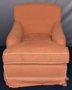 19th century style upholstered armchair with peach upholstery and cream piping in the manner of